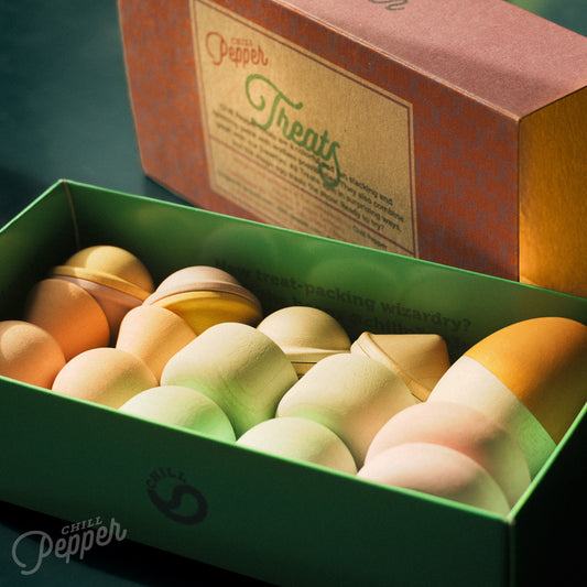 Wooden Chill Pepper Treats stacking and spinning game for ages 3 and up, made from eco-friendly maple wood and non-toxic, water-based paints. The set includes a variety of pastel-colored candy-shaped pieces and a unique Magic Egg for open-ended play.