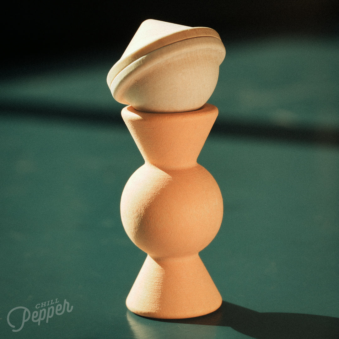 Wooden Chill Pepper Treats stacking and spinning game for ages 3 and up, made from eco-friendly maple wood and non-toxic, water-based paints. The set includes a variety of pastel-colored candy-shaped pieces and a unique Magic Egg for open-ended play.
