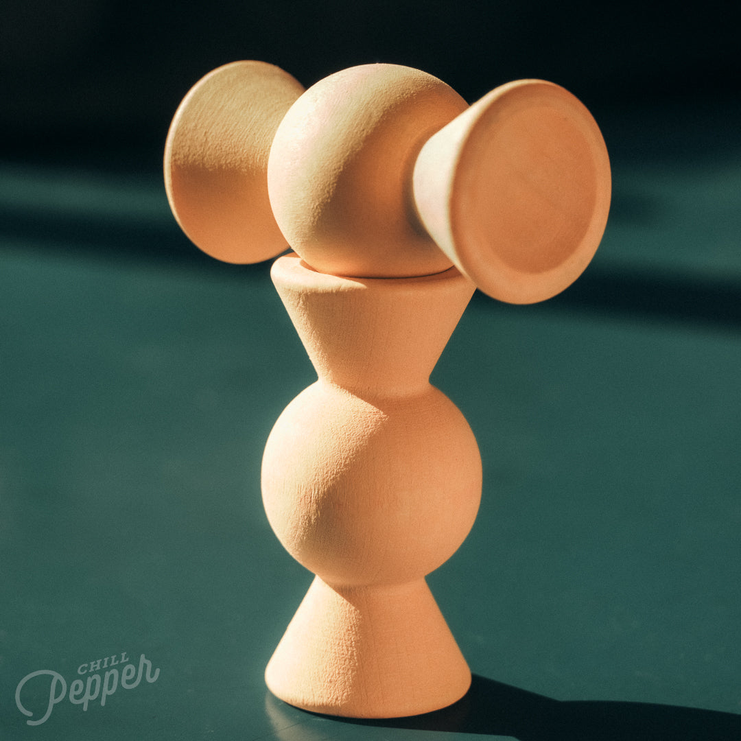 Wooden Chill Pepper Treats stacking and spinning game for ages 3 and up, made from eco-friendly maple wood and non-toxic, water-based paints. The set includes a variety of pastel-colored candy-shaped pieces and a unique Magic Egg for open-ended play.