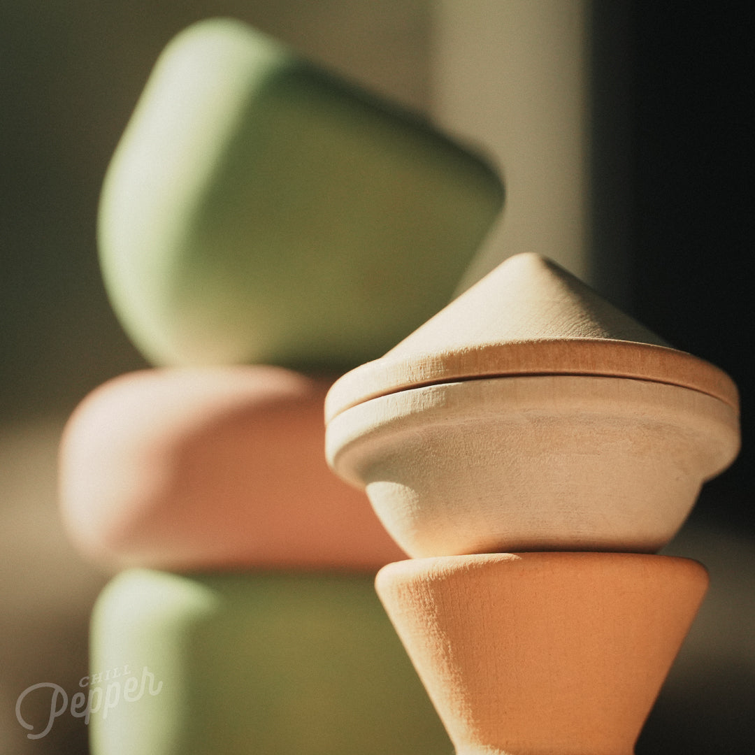 Wooden Chill Pepper Treats stacking and spinning game for ages 3 and up, made from eco-friendly maple wood and non-toxic, water-based paints. The set includes a variety of pastel-colored candy-shaped pieces and a unique Magic Egg for open-ended play.