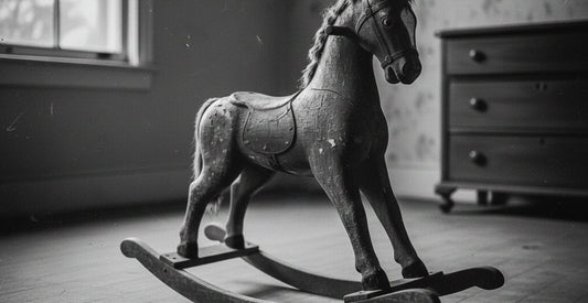 Black and white picture of a vintage wooden rocking horse in a blog about the history of wooden toys and their relation to modern wooden toys by brands like Grimm's, Grapat and Chill Pepper