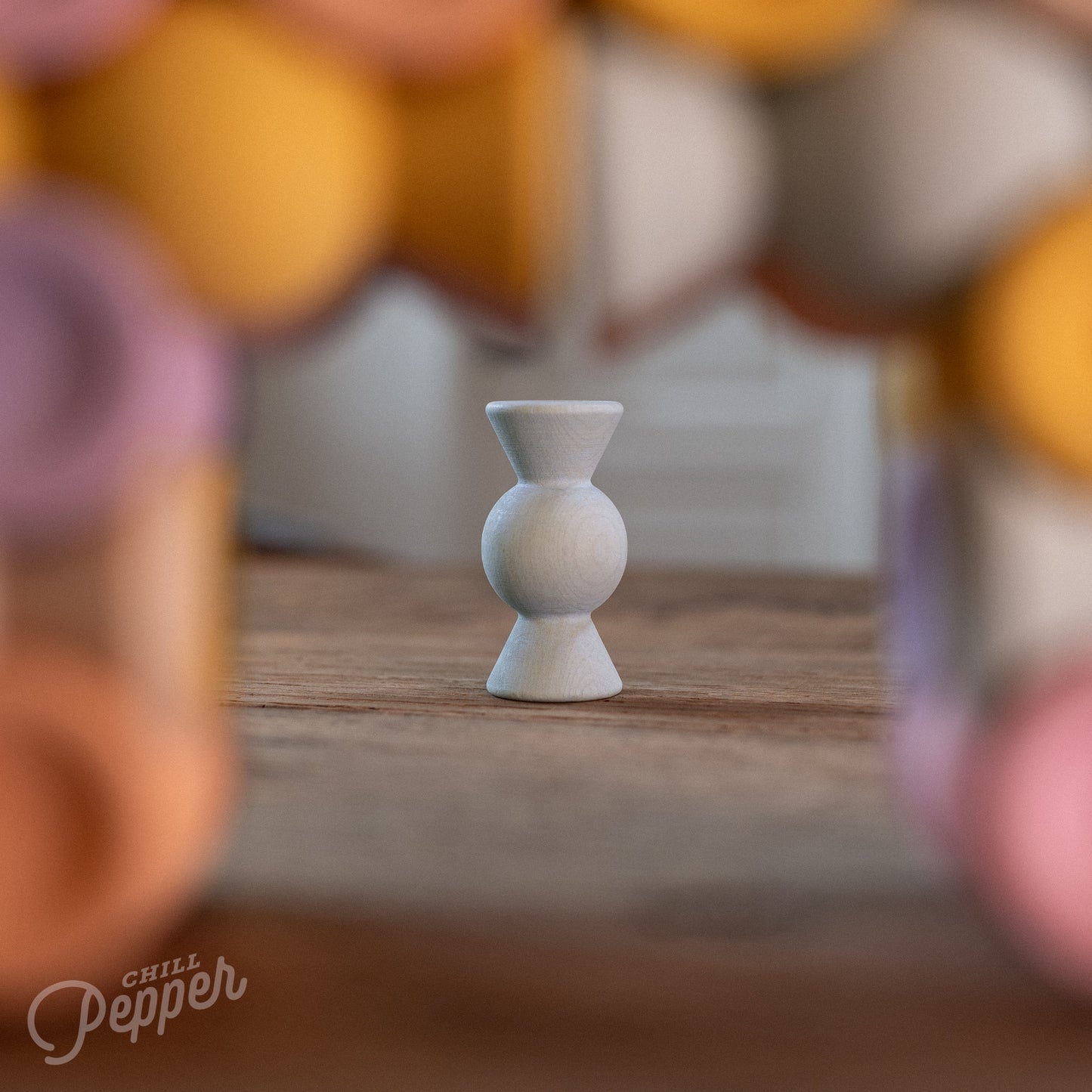 Wooden Chill Pepper Sweets stacking and spinning game for ages 3 and up, made from eco-friendly maple wood and non-toxic, water-based paints. The set includes 27 pastel-colored candy-shaped pieces and 6 gumballs for open-ended play.