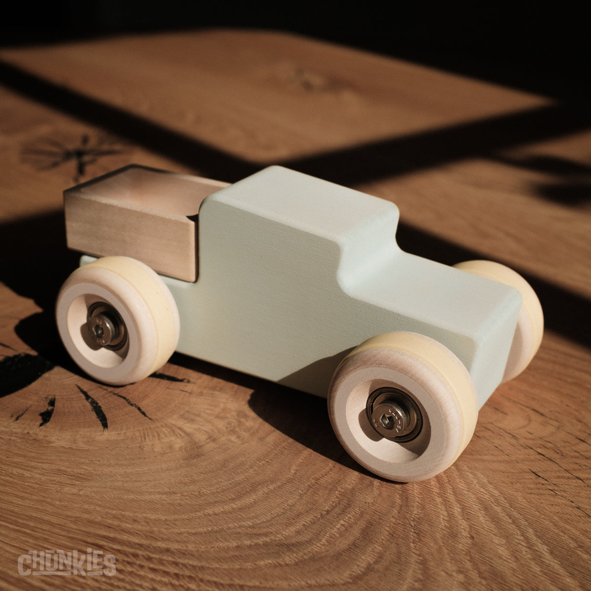Chunkies: Light blue wooden toy car in the shape of a vintage pick-up truck with wooden wheels, skate bearings and stainless steel hardware. Built to last generations. 