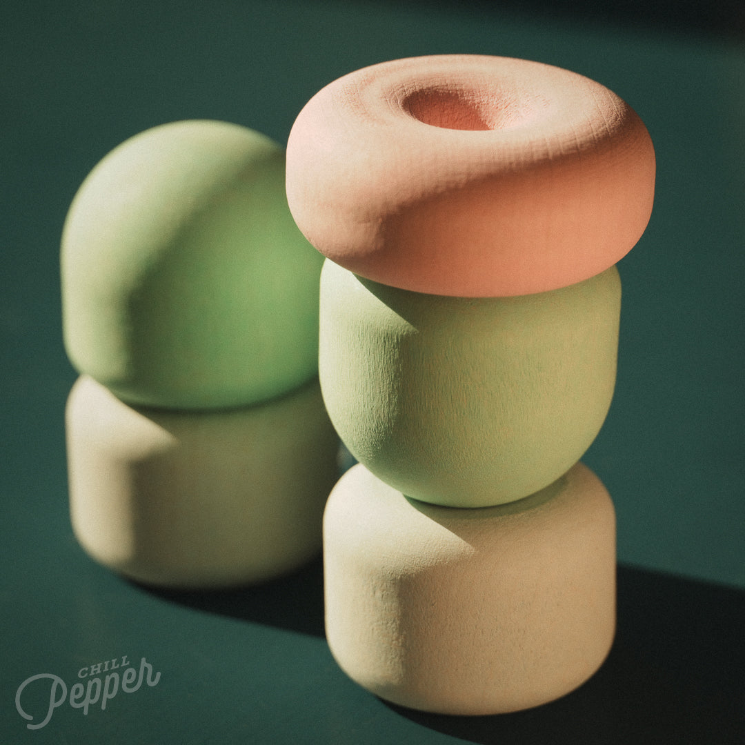 Wooden Chill Pepper Treats stacking and spinning game for ages 3 and up, made from eco-friendly maple wood and non-toxic, water-based paints. The set includes a variety of pastel-colored candy-shaped pieces and a unique Magic Egg for open-ended play.