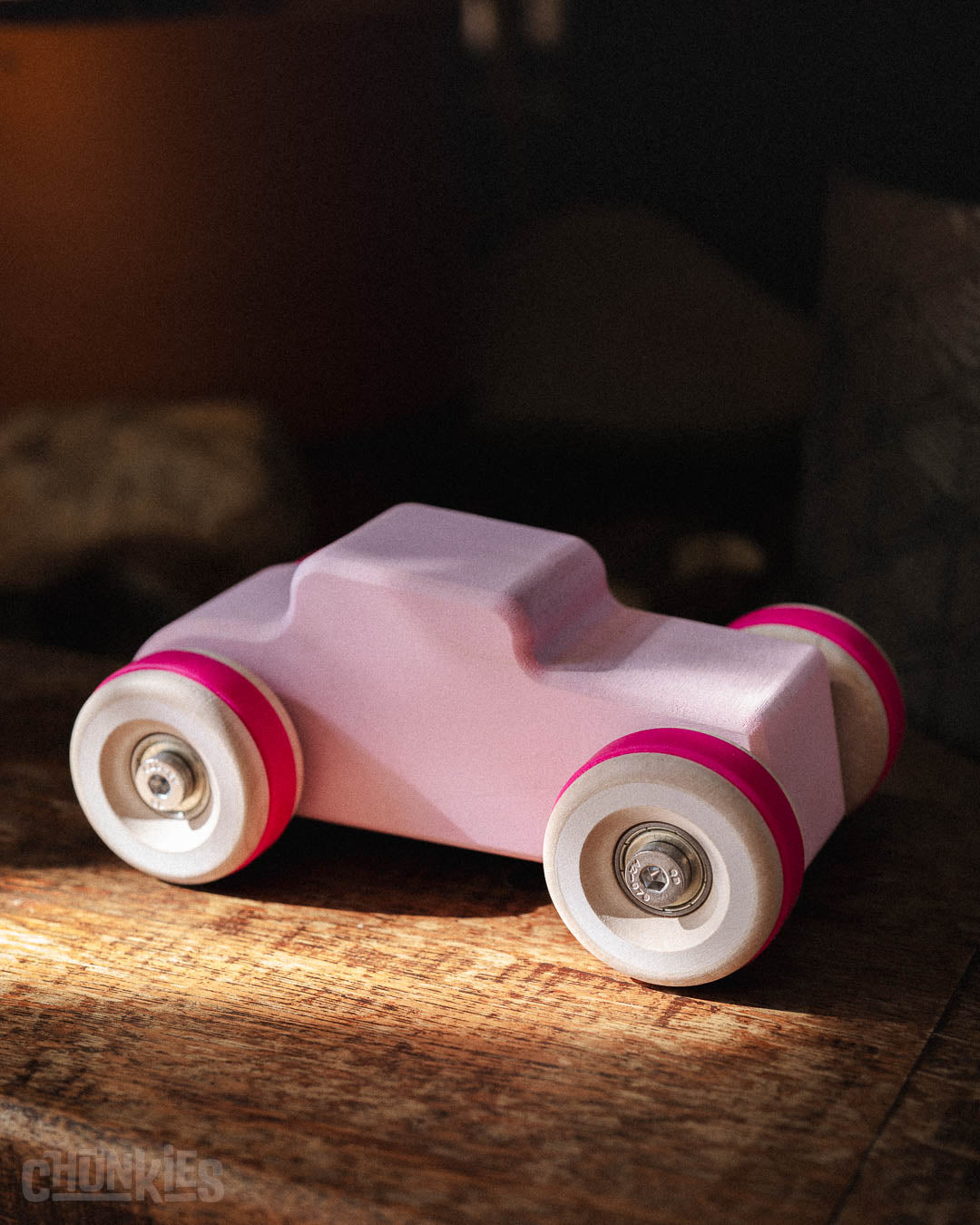 Top side view of the Chill Pepper Chunkies No04  Wooden Toy Car The Hot Rod Perfectly Pink with it's bright fuchsia tires. Ready for any type of play and fitting in any interior