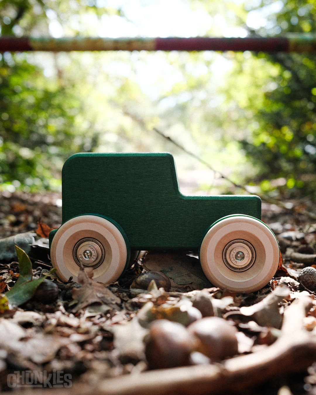 Perfect side view of the Chill Pepper Chunkies No05 Wooden Toy Car The Explorer All-Terrain in a forest