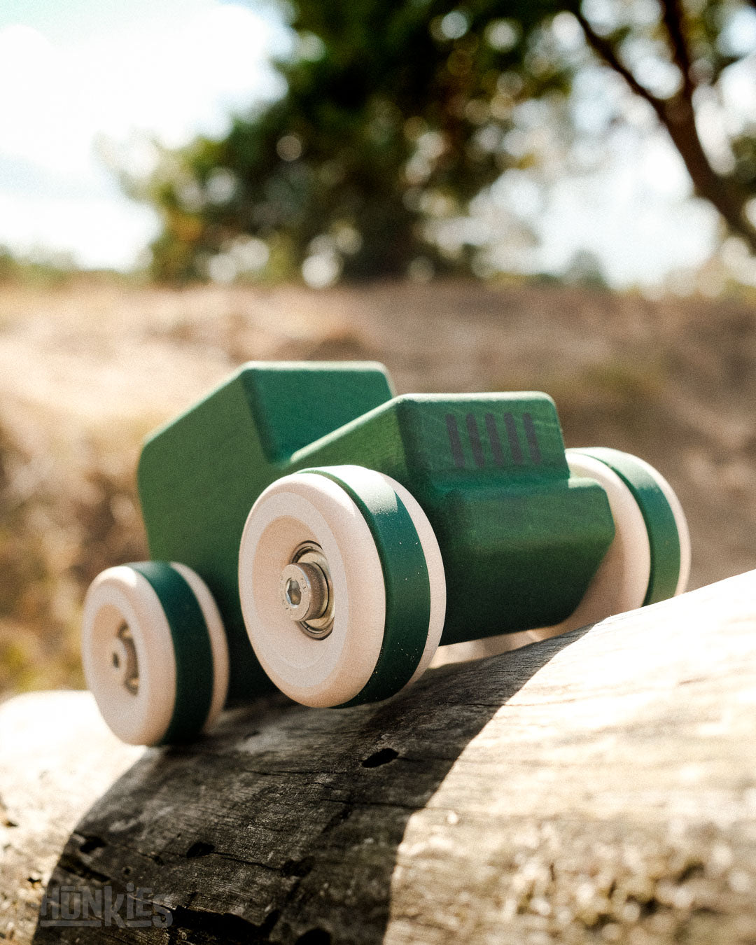 Chill Pepper Chunkies No05 Wooden Toy Car The Explorer All-Terrain climbing a log in the dunes of the Utrechtse Heuvelrug in The Netherlands: the home of Chunkies and Chill Pepper