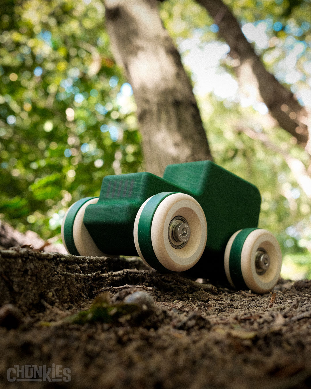 Chill Pepper Chunkies No05 Wooden Toy Car The Explorer All-Terrain. Green solid wooden toy car on a natural background with trees. Made in Europe, real skate bearings and big wooden wheels