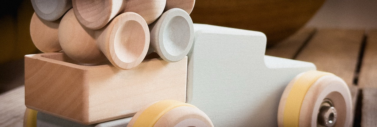 Light blue Chill Pepper Chunkies wooden Pick-Up toy car with yellow tires and real skate bearings loaded with Chill Pepper Sweets. Made in Europe