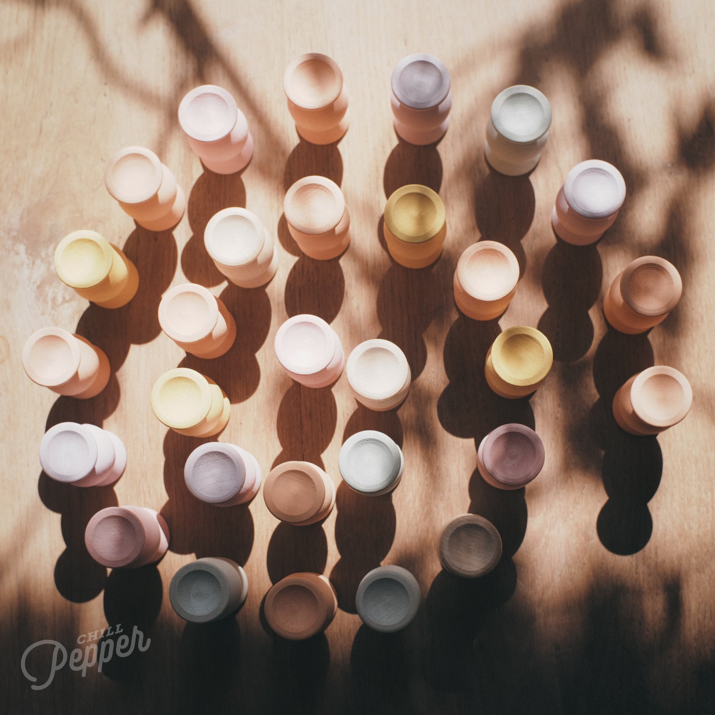 Wooden Chill Pepper Sweets stacking and spinning game for ages 3 and up, made from eco-friendly maple wood and non-toxic, water-based paints. The set includes 27 pastel-colored candy-shaped pieces and 6 gumballs for open-ended play.
