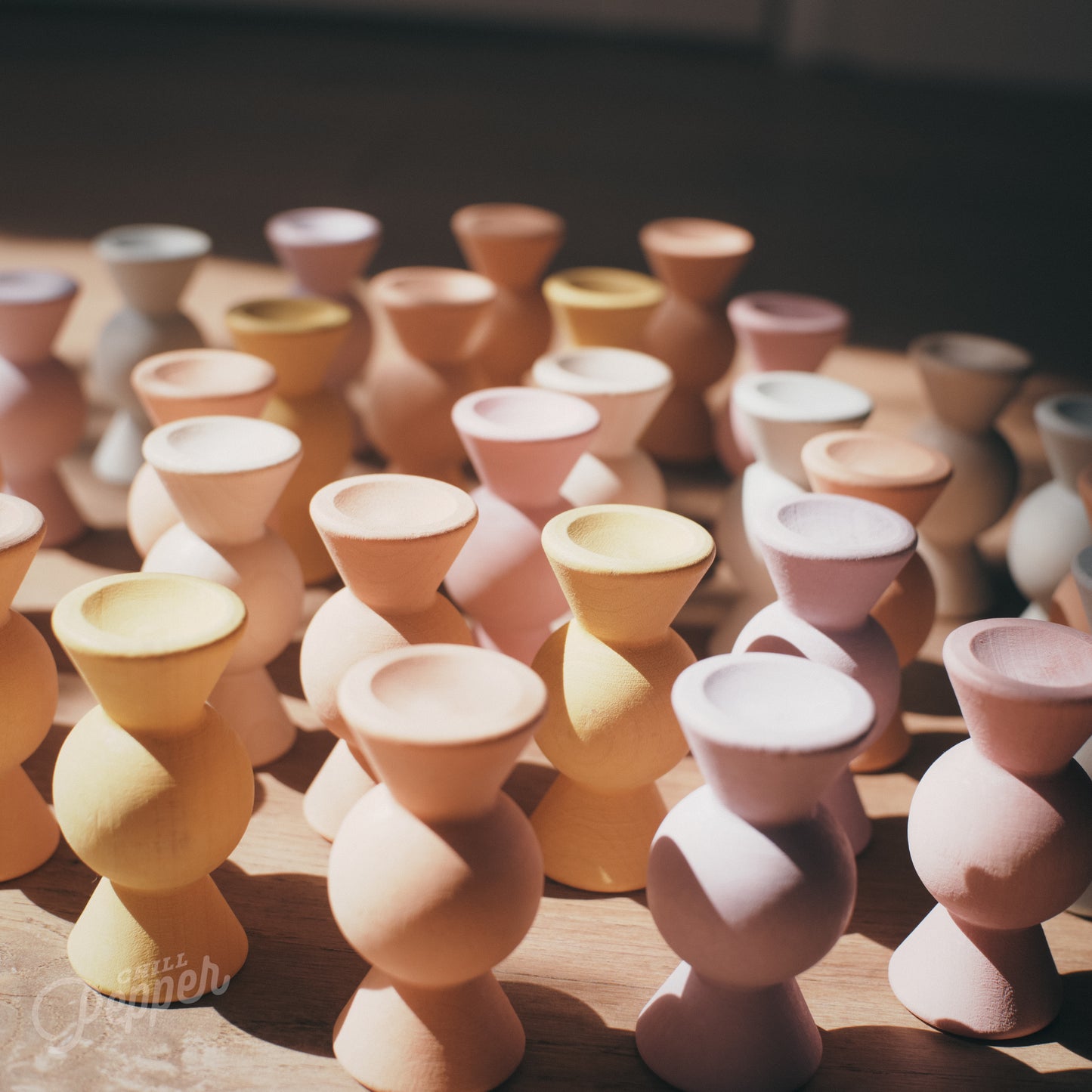 Wooden Chill Pepper Sweets stacking and spinning game for ages 3 and up, made from eco-friendly maple wood and non-toxic, water-based paints. The set includes 27 pastel-colored candy-shaped pieces and 6 gumballs for open-ended play.