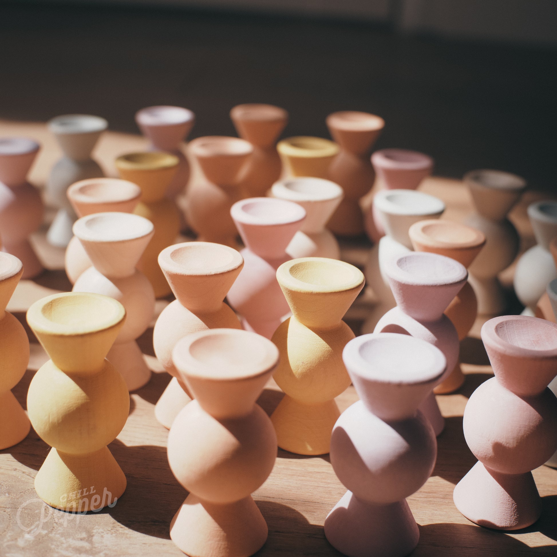 Wooden Chill Pepper Sweets stacking and spinning game for ages 3 and up, made from eco-friendly maple wood and non-toxic, water-based paints. The set includes 27 pastel-colored candy-shaped pieces and 6 gumballs for open-ended play.