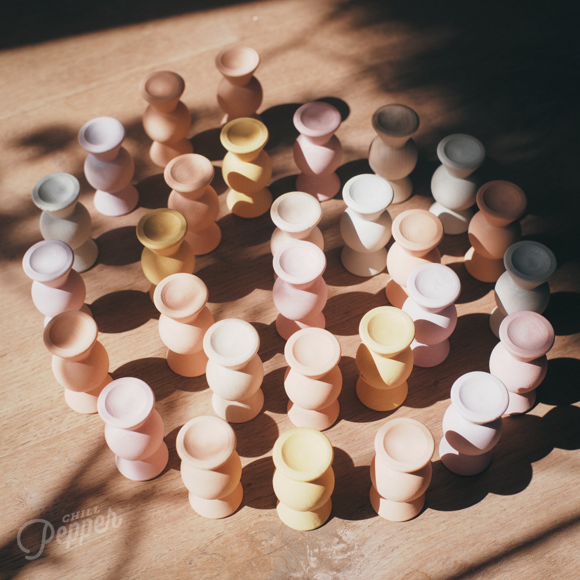 Wooden Chill Pepper Sweets stacking and spinning game for ages 3 and up, made from eco-friendly maple wood and non-toxic, water-based paints. The set includes 27 pastel-colored candy-shaped pieces and 6 gumballs for open-ended play.