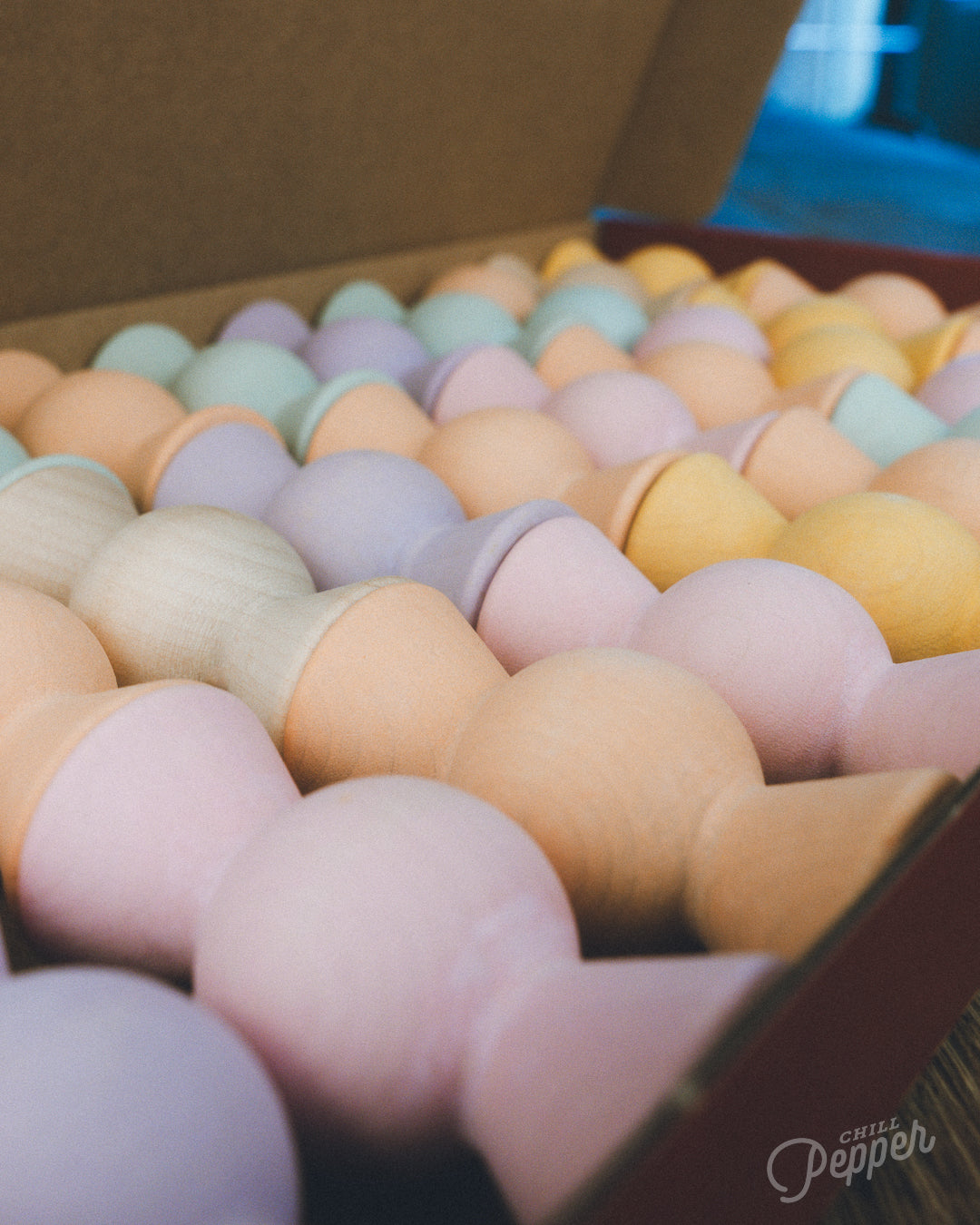 Wooden Chill Pepper Sweets stacking and spinning game for ages 3 and up, made from eco-friendly maple wood and non-toxic, water-based paints. The set includes 27 pastel-colored candy-shaped pieces and 6 gumballs for open-ended play.