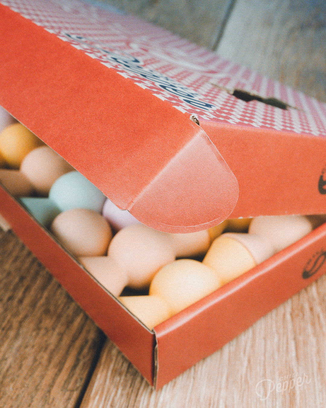 Wooden Chill Pepper Sweets stacking and spinning game for ages 3 and up, made from eco-friendly maple wood and non-toxic, water-based paints. The set includes 27 pastel-colored candy-shaped pieces and 6 gumballs for open-ended play.