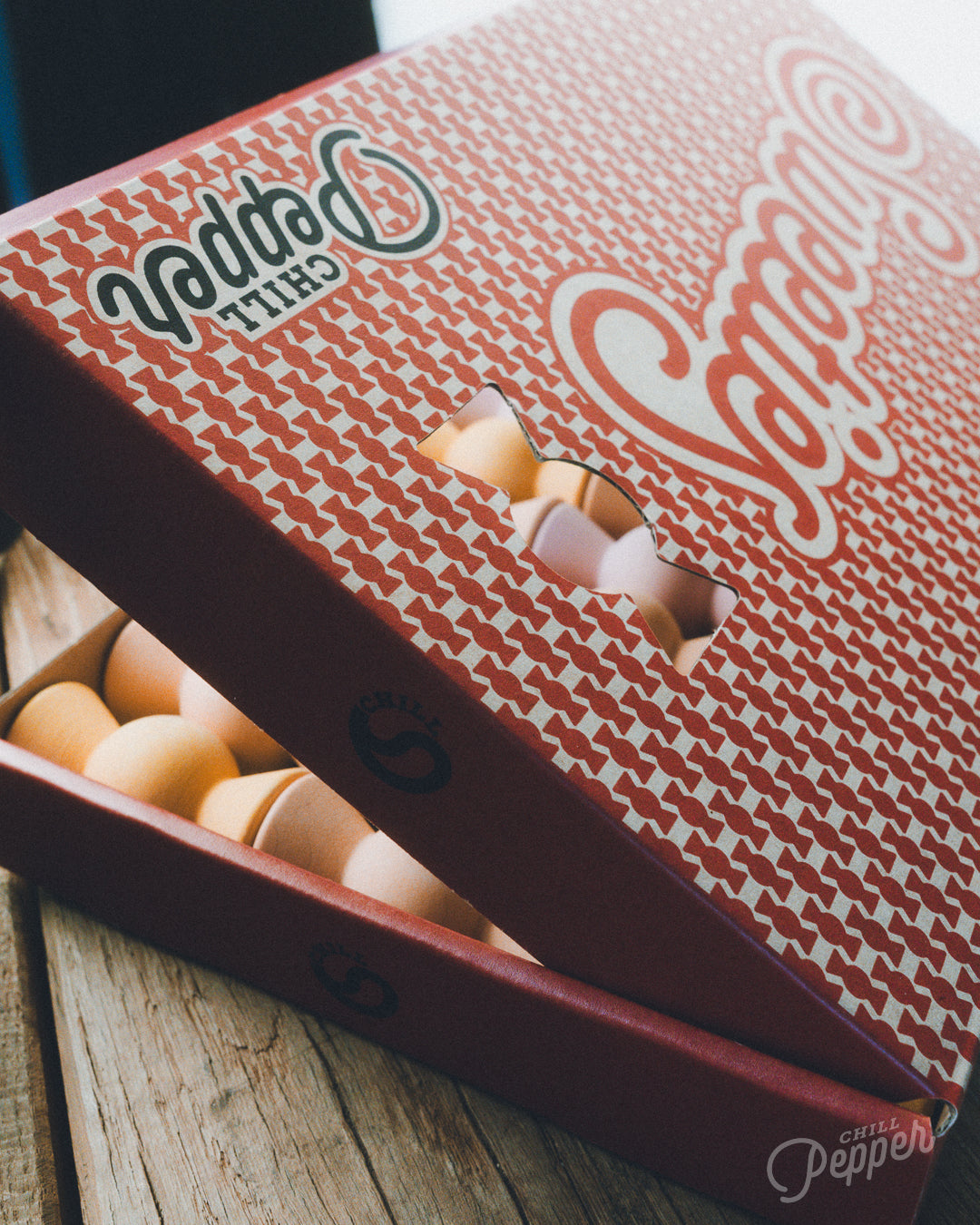 Vintage styled recycled and recyclable cardboard packaging of the Chill Pepper Sweets wooden stacking game made in Europe