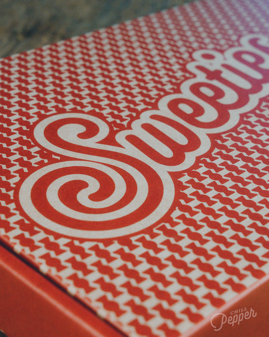 Chill Pepper Sweets Wooden Stacking game - A closer look at the vintage style lettering and pattern on the recycled cardboard packaging