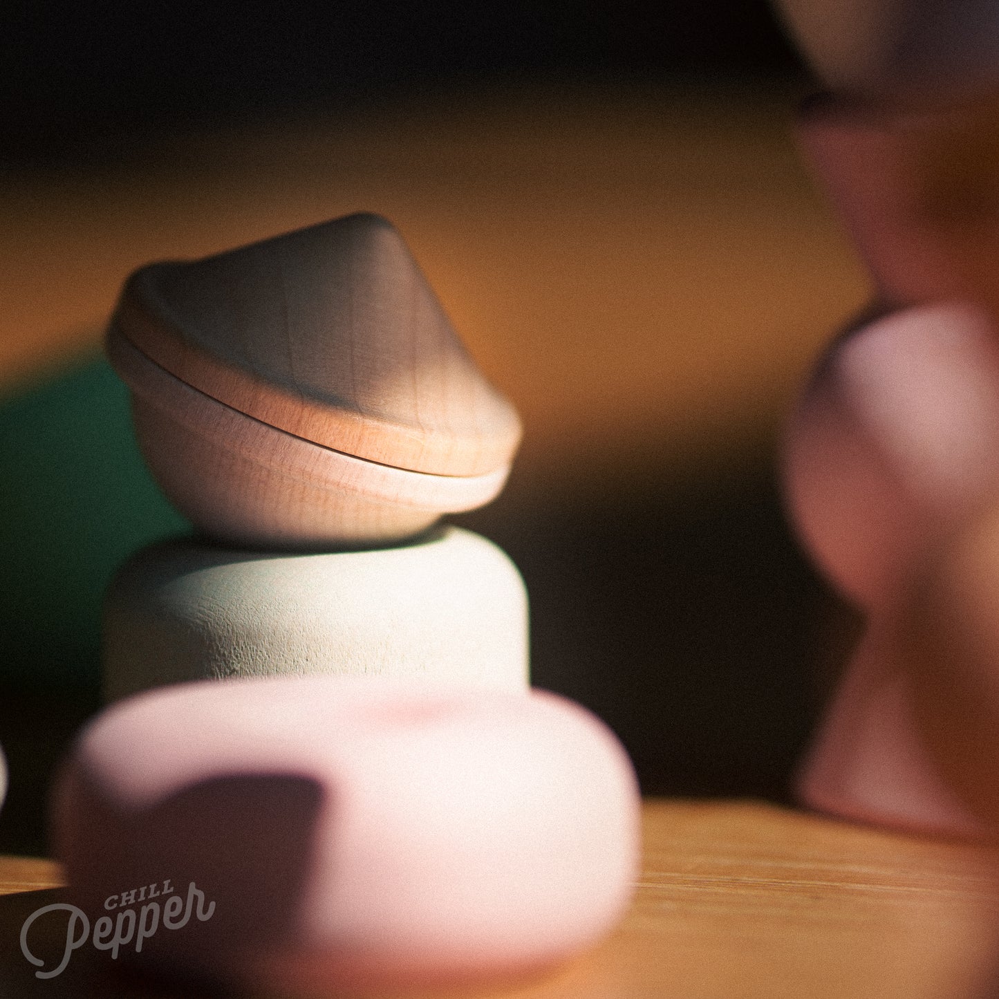 Wooden Chill Pepper Treats stacking and spinning game for ages 3 and up, made from eco-friendly maple wood and non-toxic, water-based paints. The set includes a variety of pastel-colored candy-shaped pieces and a unique Magic Egg for open-ended play.