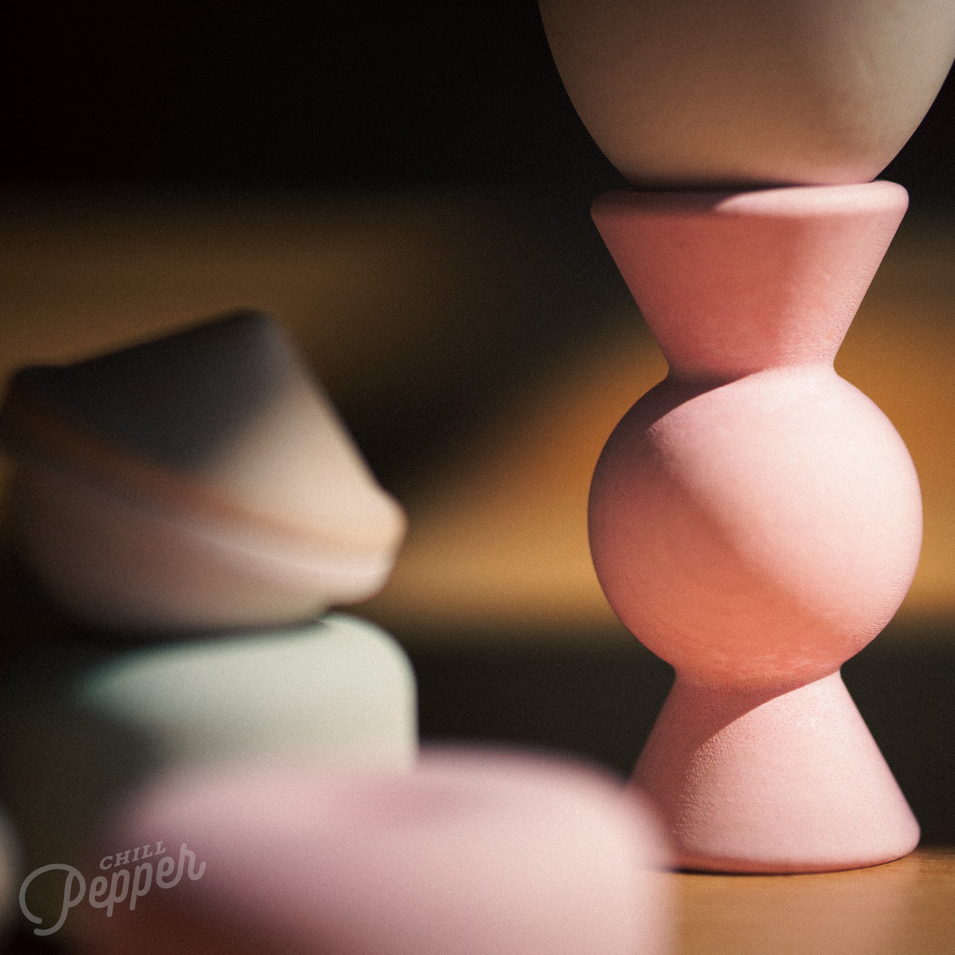 Wooden Chill Pepper Treats stacking and spinning game for ages 3 and up, made from eco-friendly maple wood and non-toxic, water-based paints. The set includes a variety of pastel-colored candy-shaped pieces and a unique Magic Egg for open-ended play.