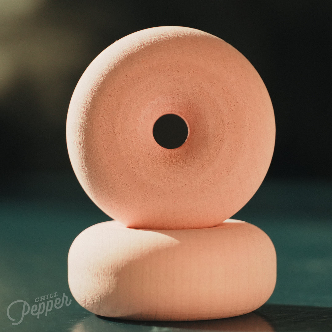Wooden Chill Pepper Treats stacking and spinning game for ages 3 and up, made from eco-friendly maple wood and non-toxic, water-based paints. On this picture the two donuts in pastel Perfectly Pink