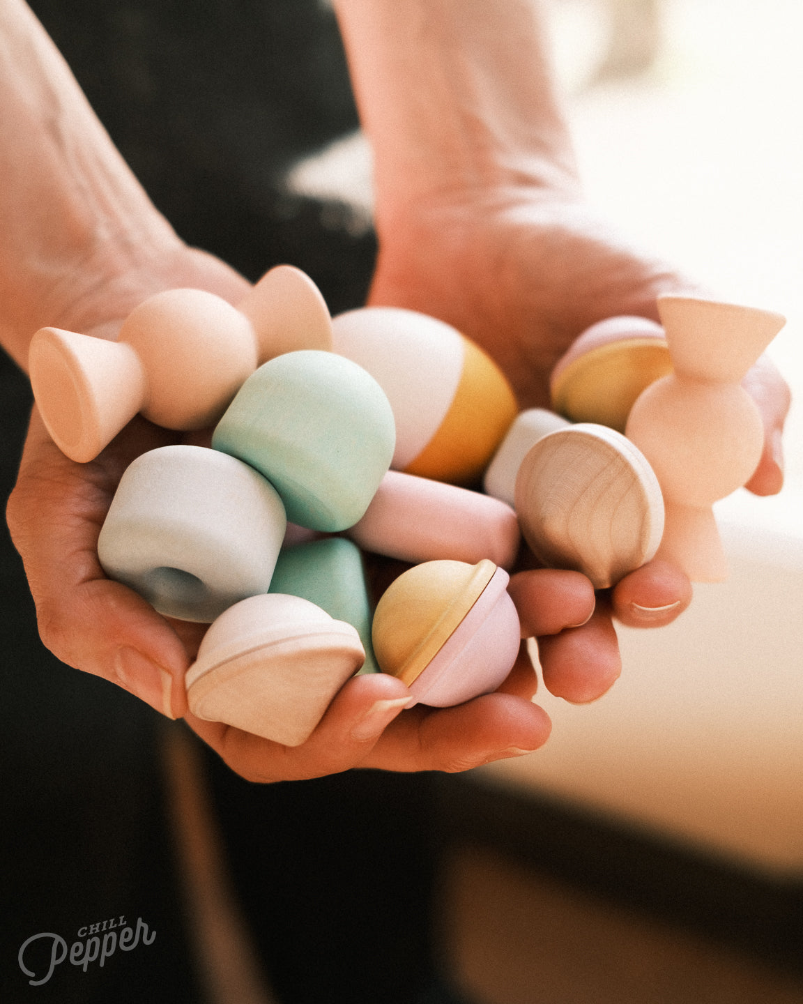 Chill Pepper Treats wooden stacking and spinning toys. Handheld to show what's in the box. Made in Europe. Sustainable open ended play. Montessori and Waldorf toys