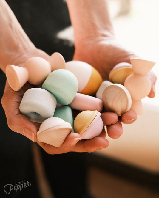 Chill Pepper Treats wooden stacking and spinning toys. Handheld to show what's in the box. Made in Europe. Sustainable open ended play. Montessori and Waldorf toys