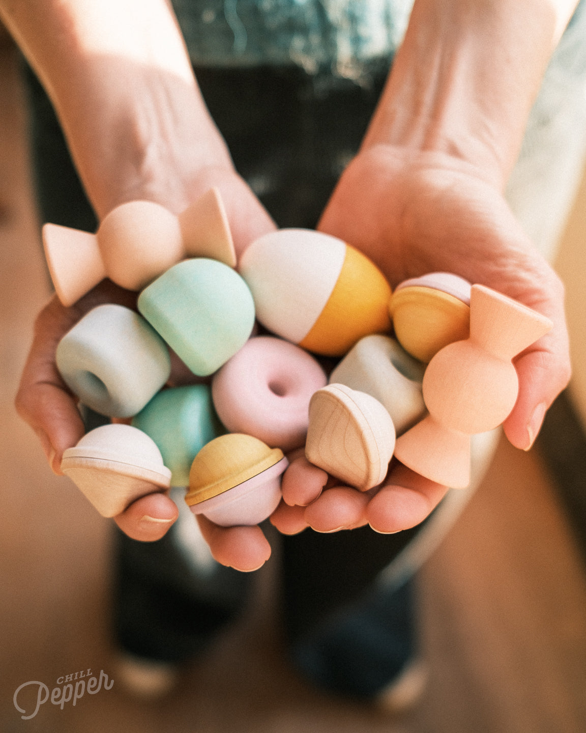 Chill Pepper Treats wooden stacking and spinning game. Handheld to show what's in the box. Made in Europe. Sustainable open ended play. Waldorf inspired