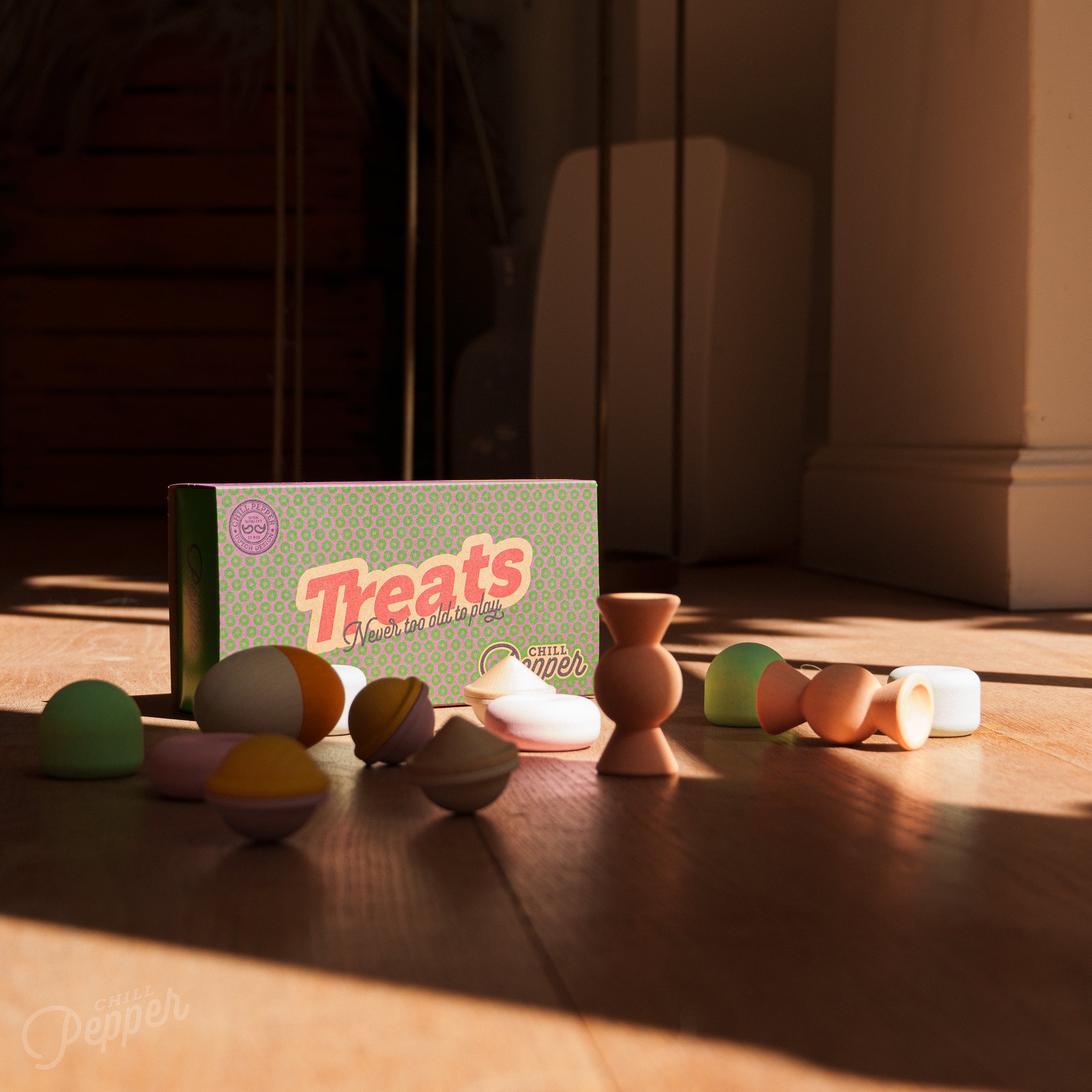 Chill Pepper Treats and their packaging spread on the floor in bright sunlight