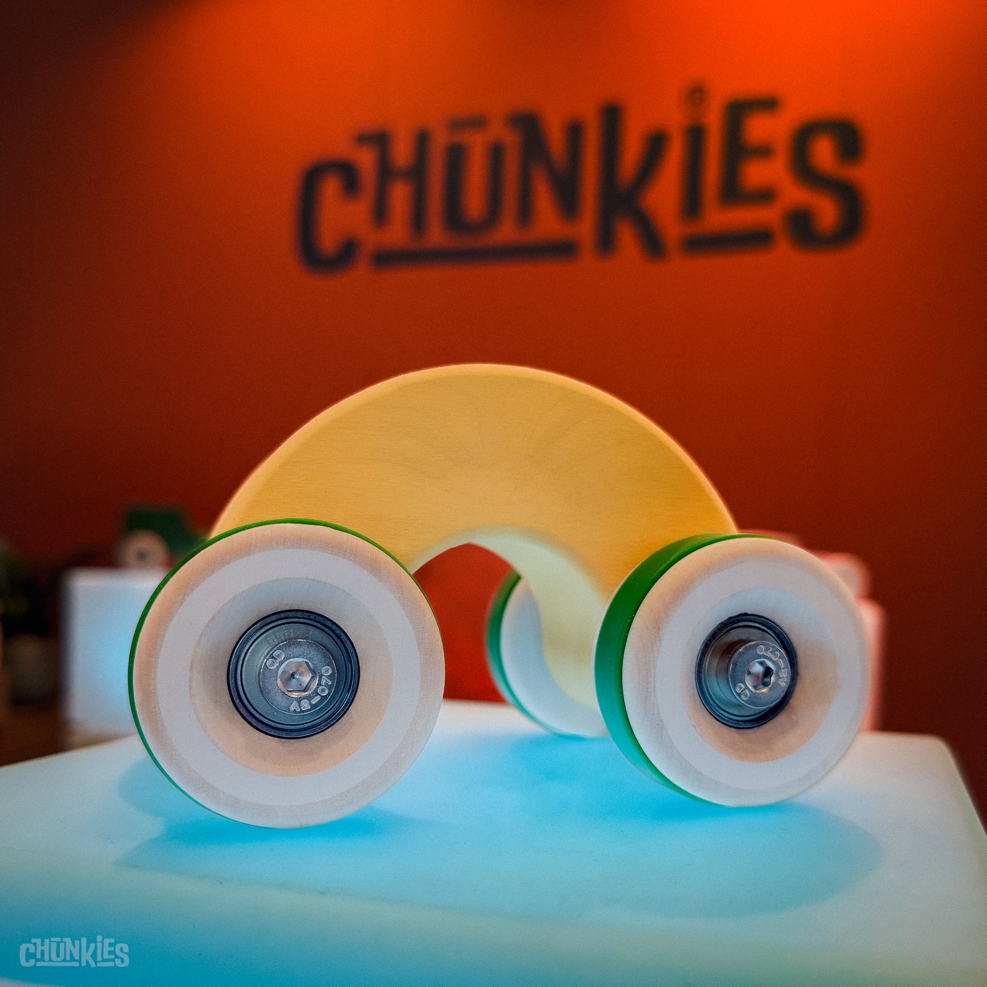 Chunkies: Yellow wooden toy car in the shape of a arch with wooden wheels, skate bearings and stainless steel hardware. Built to last generations. 