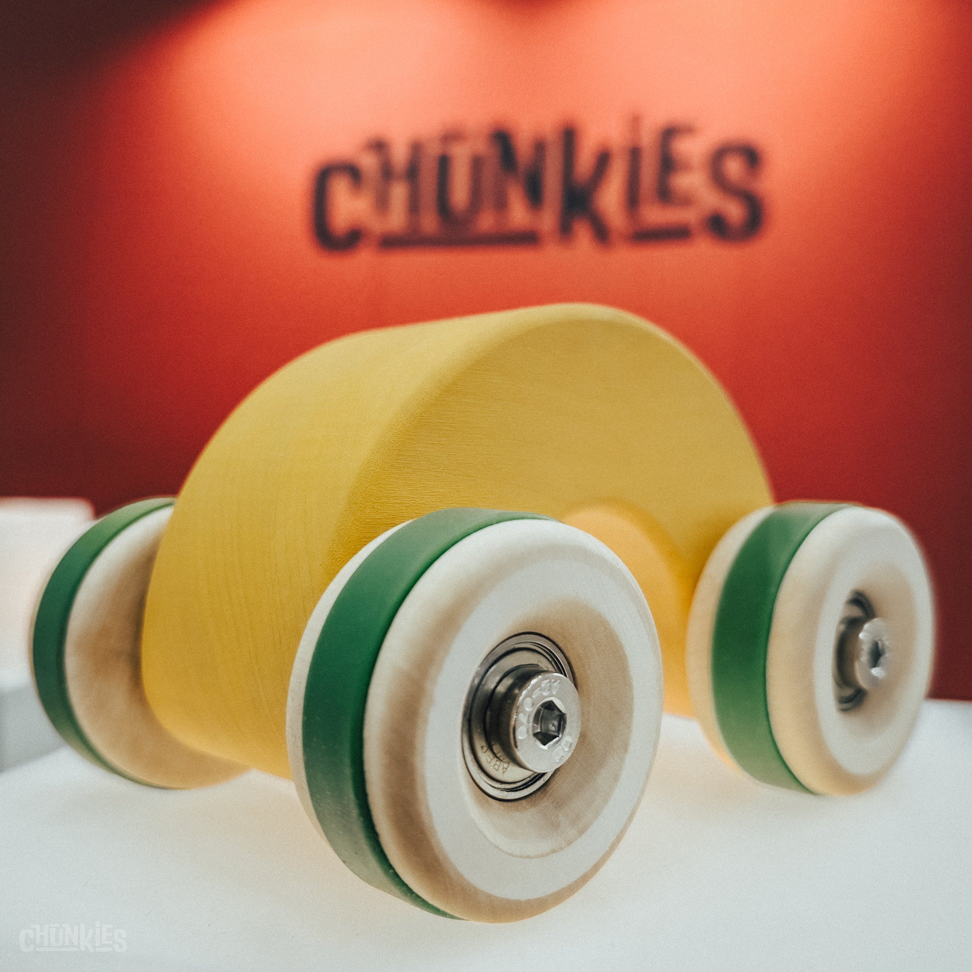 Chunkies: Yellow wooden toy car in the shape of a arch with wooden wheels, skate bearings and stainless steel hardware. Built to last generations. 