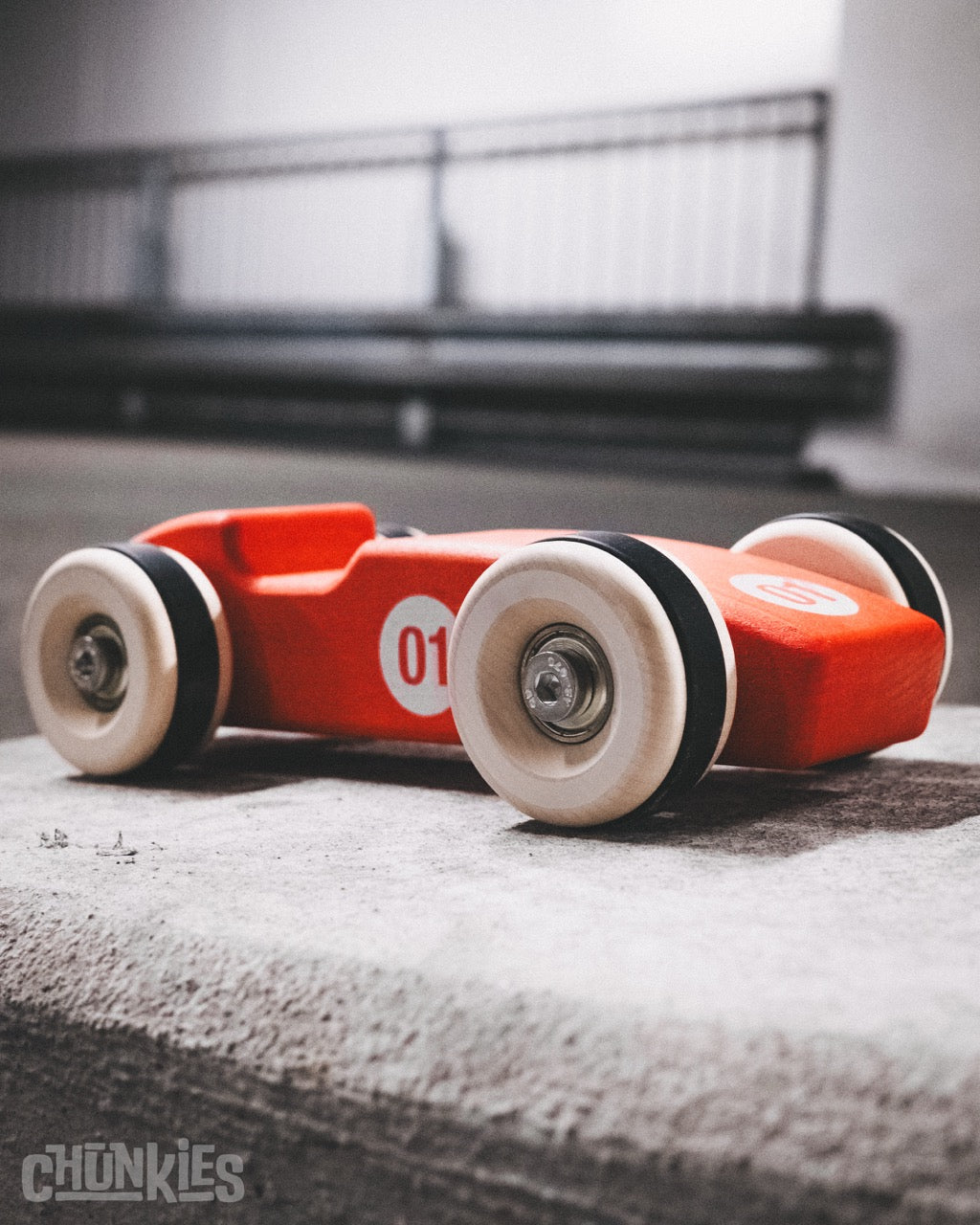 Chunkies No. 01 – Wooden Racing Car The 1956 Legend - Big Classic wooden toy car made in Europe and on big wheels with skate bearings for an ultra smooth ride. Made to last. Shown here in an urban parking garage for a cool vibe