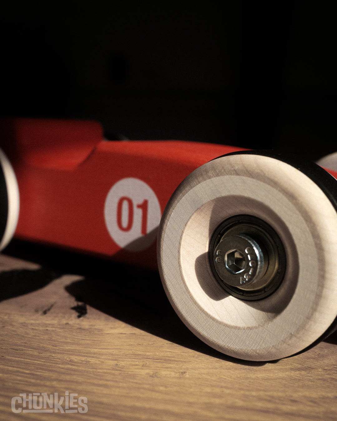Detail of solid Maple wooden wheel with real high-speed skate bearings on Chunkies toy car, Made in Germany assembled in The Netherlands. Planet and child friendly