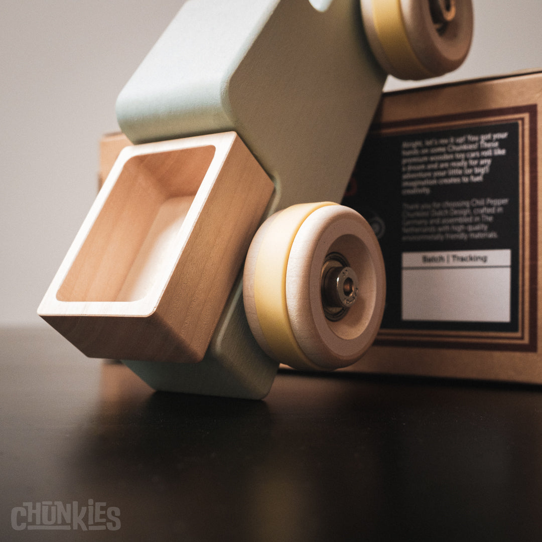 Sustainable cardboard packaging for Chill Pepper wooden trucks including spare tires kit. Chunkies: Light blue wooden toy car in the shape of a vintage pick-up truck with wooden wheels, skate bearings and stainless steel hardware. Built to last generations. 