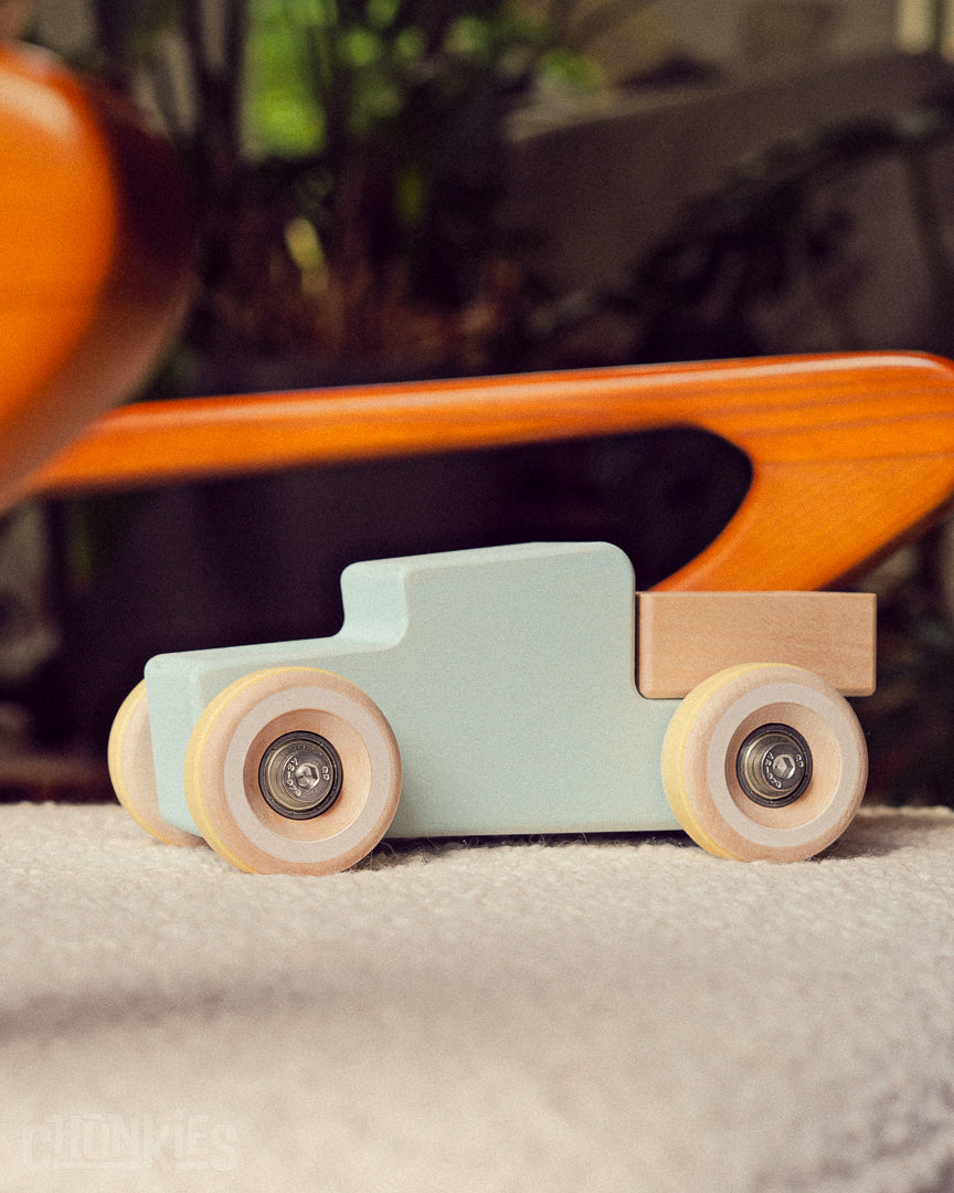 Chunkies big wooden toy truck made in Europe here sat on a comfortable chair. Made for every interior, never out of style due to vintage style and high quality matte finish.