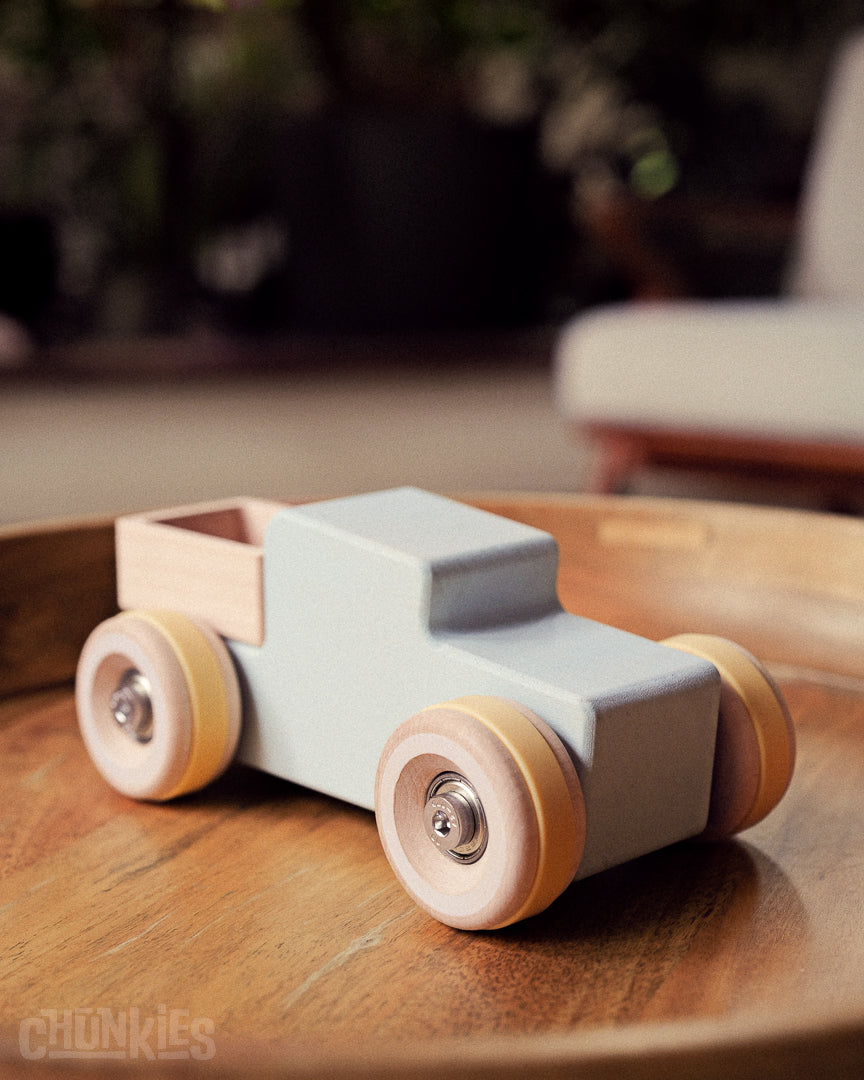 Chunkies No. 02 Wooden Pick-Up Truck "The Workhorse" in Brilliant Blue - 3/4 view interior setting. Big wooden wheels, solid sustainable wooden body and skate bearings for the smoothest ride ever