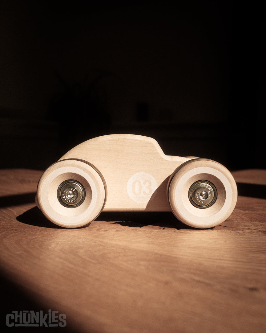 Straight side view of the curvy Chunkies Bug made by Chill Pepper in Europe. A solid wooden toy car for kids and collectors. Sustainable materials and packaging